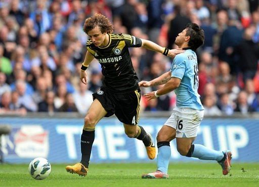 David Luiz (L) is challenged by Sergio Aguero at Wembley Stadium in north London on April 14, 2013
