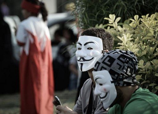 Bahraini protestors wearing Guy Fawkes masks rally in Jidhafs, west of Manama on April 15, 2013