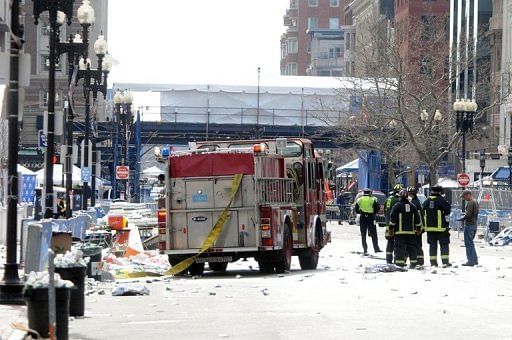 Firefighters take postion near the finish line after two bombs exploded during the Boston Marathon on April 15, 2013