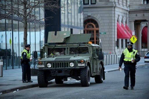 Boston police officers stand near a Humvee, April 16, 2013 in Boston, Massachusetts