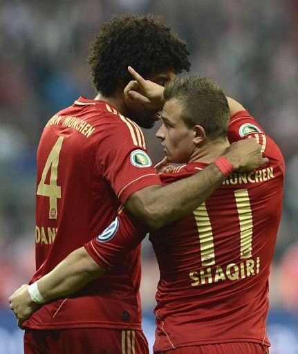 Bayern Munich&#039;s Xherdan Shaqiri (R) and Dante celebrate in Munich on April 16, 2013