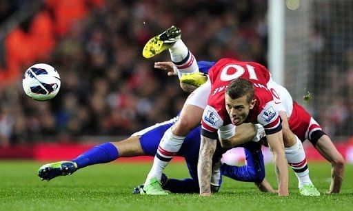 Arsenal midfielder Jack Wilshere (R) and Everton&#039;s Steven Pienaar are pictured during their match on April 16, 2013