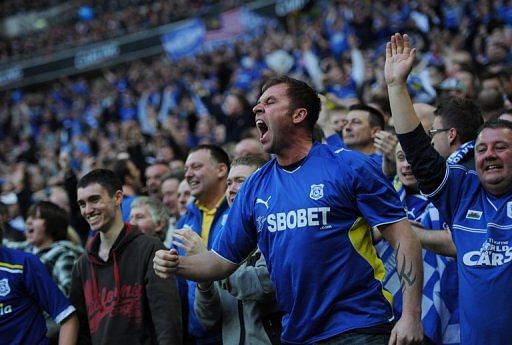 Cardiff City fans celebrate a goal at Wembley Stadium in London, on February 26, 2012