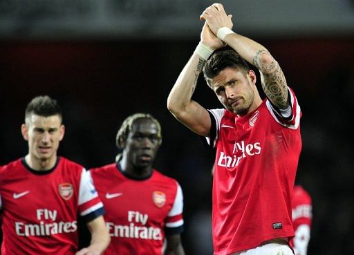 Arsenal striker Olivier Giroud acknowledges the crowd after their 0-0 draw against Everton in London on April 16, 2013