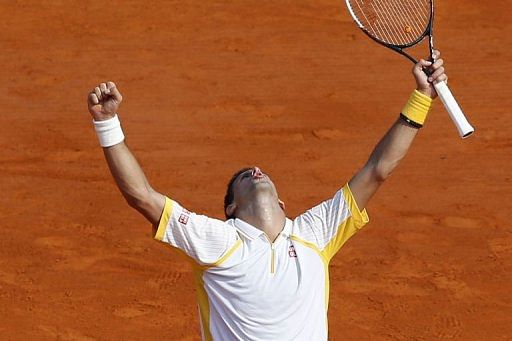 Serbian Novak Djokovic celebrates after winning the match against Russian Mikhail Youzhny, on April 17, 2013