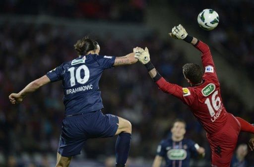 Paris&#039; Zlatan Ibrahimovic (L) fights for the ball with Evian&#039;s goalkeeper Johann Durand (R) on April 17, 2013 in Annecy