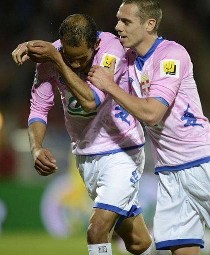 Evian&#039;s Saber Kalhifa (L) is congratulated by his teammate Kevin Berigaud (R) after scoring on April 17, 2013 in Annecy