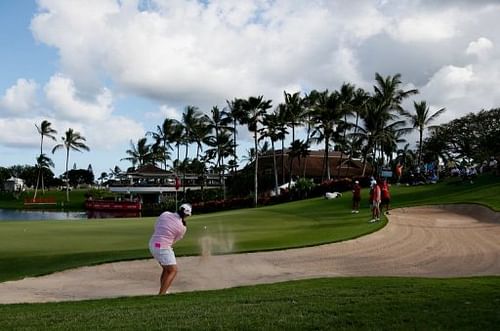 Ariya Jutanugarn of Thailand hits out of the sand on the 18th hole on April 17, 2013 in Kapolei, Hawaii