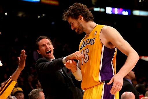 Injured player Steve Nash (L) of the Los Angeles Lakers greets Pau Gasol as he comes off the floor, April 17, 2013