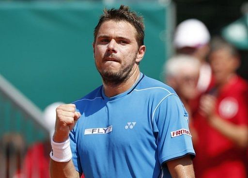 Stanislas Wawrinka celebrates after winning his match against Andy Murray in Monaco on April 18, 2013