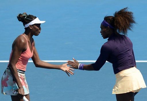 Serena (R) and Venus Williams at the Australian Open in Melbourne on January 20, 2013