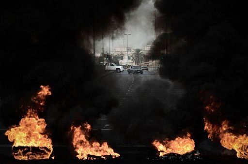 Tyres placed by anti-regime protestors burn during clashes with riot police on April 18, 2013 in Diraz, west of Manama