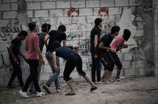 Protesters prepare to throw stones at police during clashes over the arrival of the Grand Prix on April 18, 2013