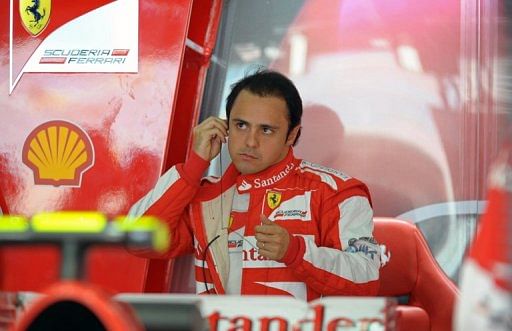 Felipe Massa puts in his earplugs during the first practice session in Manama on April 19, 2013