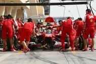 Ferrari mechanics change tyres on Felipe Massa's car at the Bahrain International Circuit in Manama, on April 19, 2012