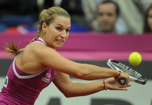 Slovakia's Dominika Cibulkova returns a shot to Russia's Anastasia Pavlyuchenkova on April 20, 2013