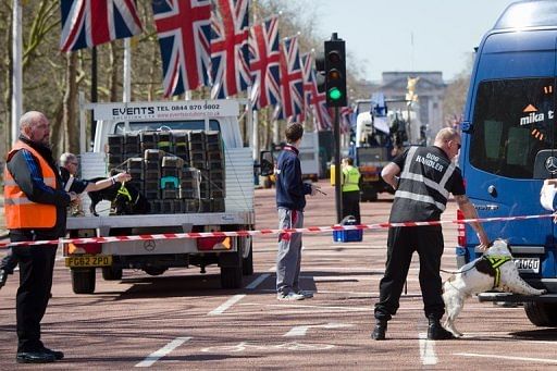 A handler works with an explosive-detecting dog on The Mall in central London on April 20, 2013
