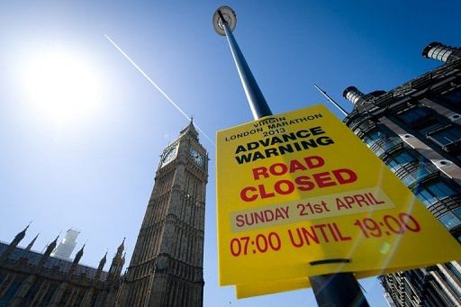 Road signs warn of impending road closures in central London on April 20, 2013