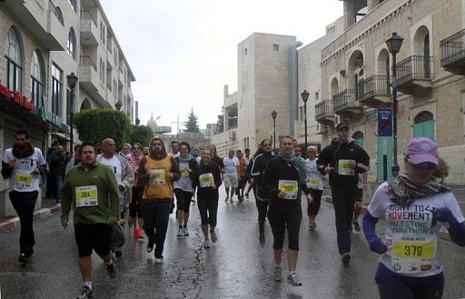 Competitors run the first marathon in the West Bank town of Bethlehem on April 21, 2013