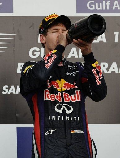 Sebastian Vettel celebrates on the podium at the Bahrain International Circuit in Manama on April 21, 2013