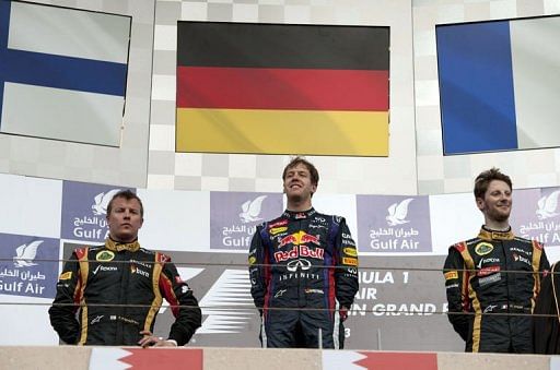 (L to R) Kimi Raikkonen, Sebastian Vettel and Romain Grosjean celebrate on the podium in Manama on April 21, 2013