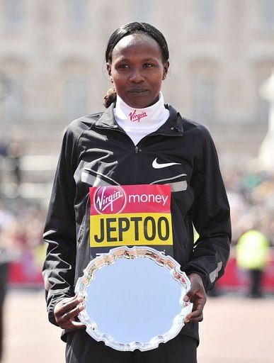 Priscah Jeptoo of Kenya poses with her trophy in London on April 21, 2013