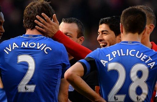 Liverpool&#039;s Luis Suarez pats Chelsea&#039;s Branislav Ivanovic on the head after the biting incident on April 21, 2013