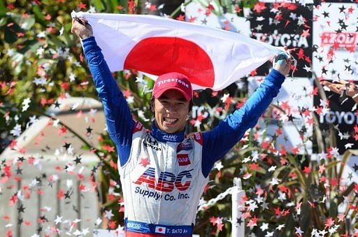 Takuma Sato celebrates becoming the first Japanese driver to win a race in the US open-wheel series, on April 21, 2013