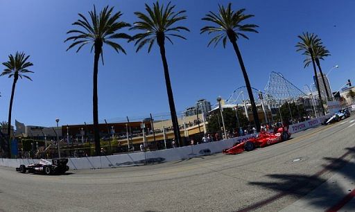 Cars stream along the streets of Long Beach, California for the grand prix on April 21, 2013