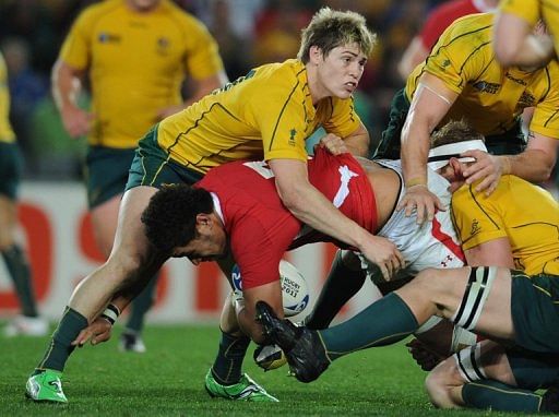 Wallabies James O&#039;Connor (top) vies with Wales&#039; Toby Faletau during the Rugby World Cup in Auckland on October 21, 2011
