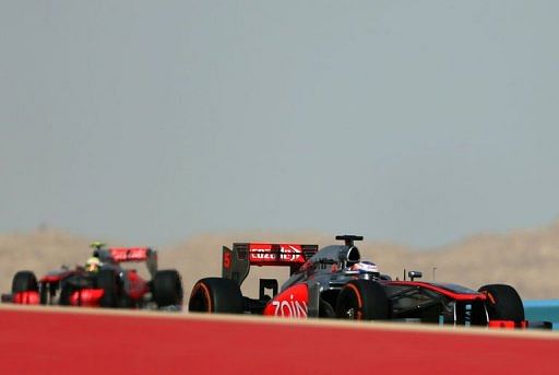 McLaren&#039;s Sergio Perez (left) and Jenson Button drive in Manama on April 21, 2013 during the Bahrain F1 Grand Prix