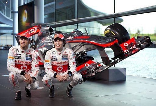 F1 drivers Sergio Perez (right) and Jenson Button at the unveiling of the McLaren racing car in Woking, January 31, 2013