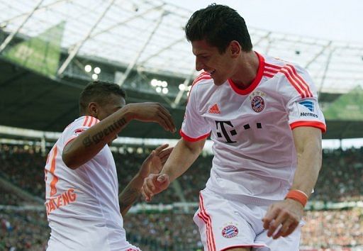 Bayern Munich striker Mario Gomez (R) celebrates his goal with defender Jerome Boateng on April 20, 2013
