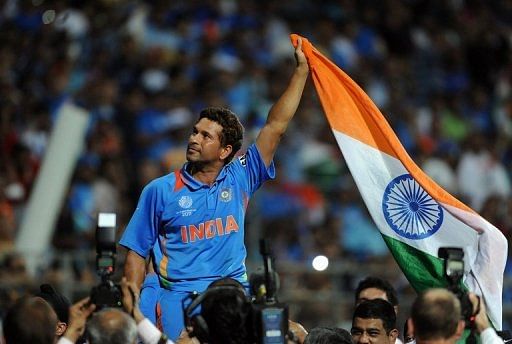 Sachin Tendulkar waves the Indian flag as he celebrates his team&#039;s World Cup win on April 2, 2011