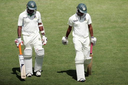Bangladesh&#039;s SK Robiul Islam (L) and Rubel Hossain walk off the pitch during the first Zimbabwe test on April 19, 2013
