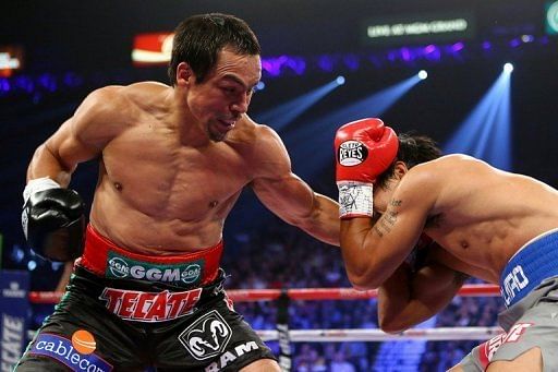 Juan Manuel Marquez (L) throws a left during his welterweight bout against Manny Pacquiao on December 8, 2012