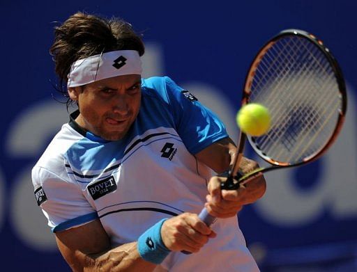 Spanish player David Ferrer returns a ball to Russian player Dmitry Tursunov in Barcelona on April 24, 2013