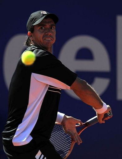 Argentinian player Carlos Berlocq returns a ball to Spanish player Rafael Nadal in Barcelona on April 24, 2013