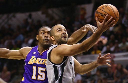 Tony Parker (R) of the San Antonio Spurs takes a shot during the game against the Los Angeles Lakers on April 24, 2013