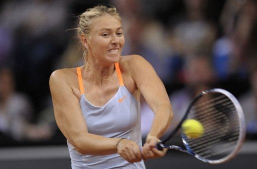 Russia&#039;s Maria Sharapova returns the ball to Czech&#039;s Lucie Safarova in Stuttgart, southwestern Germany, April 25, 2013