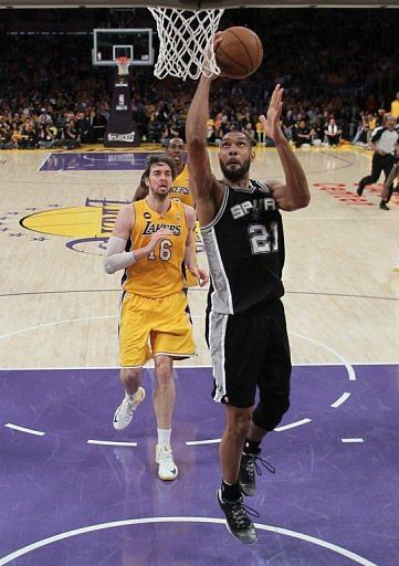 Tim Duncan of the San Antonio Spurs drives to the basket past Pau Gasol of the Los Angeles Lakers, on April 26, 2013