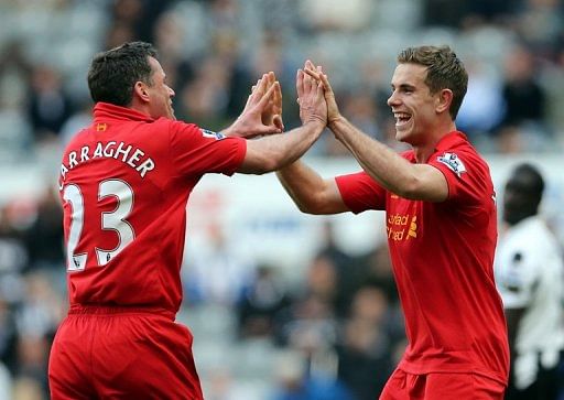 Liverpool midfielder Jordan Henderson (R) celebrates scoring at Newcastle, with Jamie Carragher, on April 27, 2013