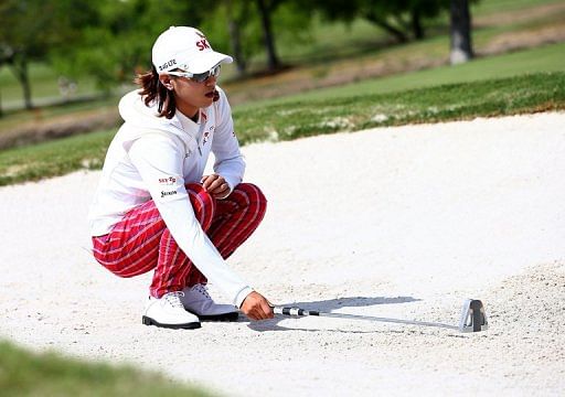 Choi Na-Yeon marks her ball in a bunker during the third round of the North Texas LPGA Shootout on April 27, 2013