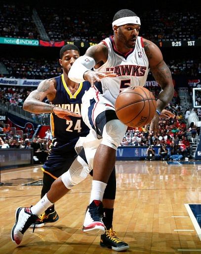 Josh Smith of the Atlanta Hawks drives past Paul George of the Indiana Pacers on April 27, 2013