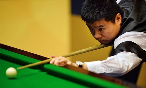 Ding Junhui lines up a shot during the World Snooker Championship 2013 first round match in England, on April 24, 2013