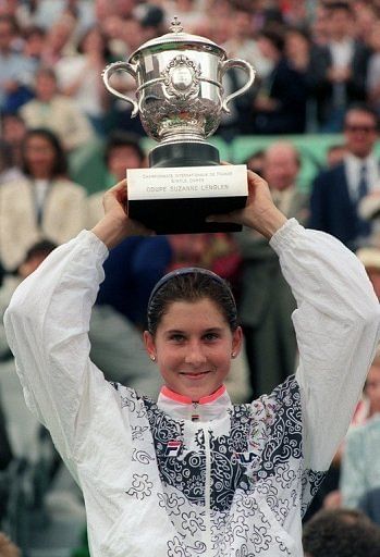 Monica Seles holds up the winner's trophy after defeating Steffi Graf on June 6, 1992 to win the French Open