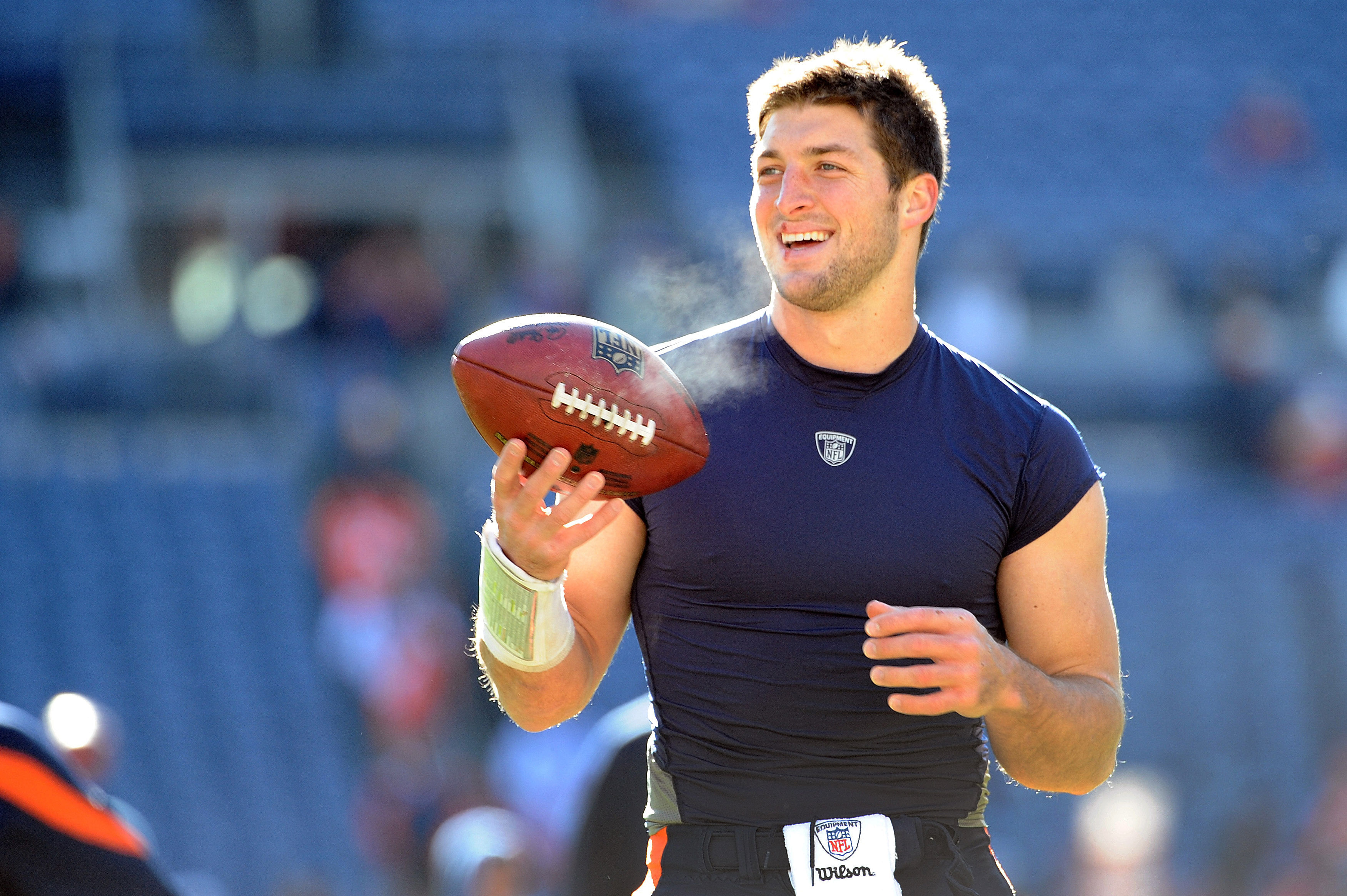 Tim Tebow fan Bob Brown, wearing a University of Florida jersey, cheers as  New York Jets quarterback Tim Tebow leaves the field after warming up prior  to an NFL football game against