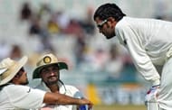 Indian cricket captain Mahendra Singh Dhoni (R) talks to players Zaheer Khan (L) and Harbhajan Singh (C) during the drinks break on the second day of the first Test between India and Australia in Mohali on October 2, 2010.