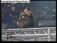 Video: Undertaker throws Rikishi off the cage.