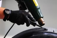 Pirelli technician works on tyres in the paddock during practice for the European Formula One Grand Prix at the Valencia Street Circuit on July 24, 2011, in Valencia, Spain. (Photo by Clive Rose/Getty Images)
